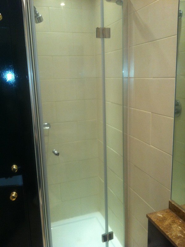 Frameless glass shower enclosure with chrome fittings in Streatham Hill