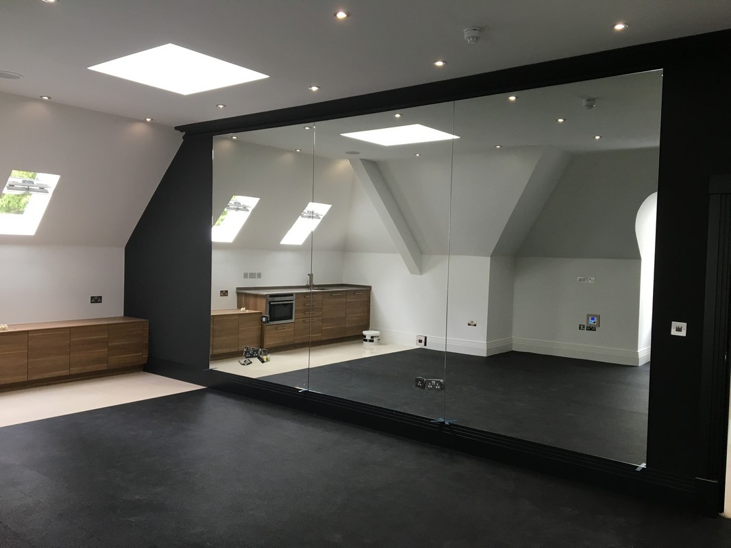Frameless glass wall dividing loft conversion in Streatham Hill