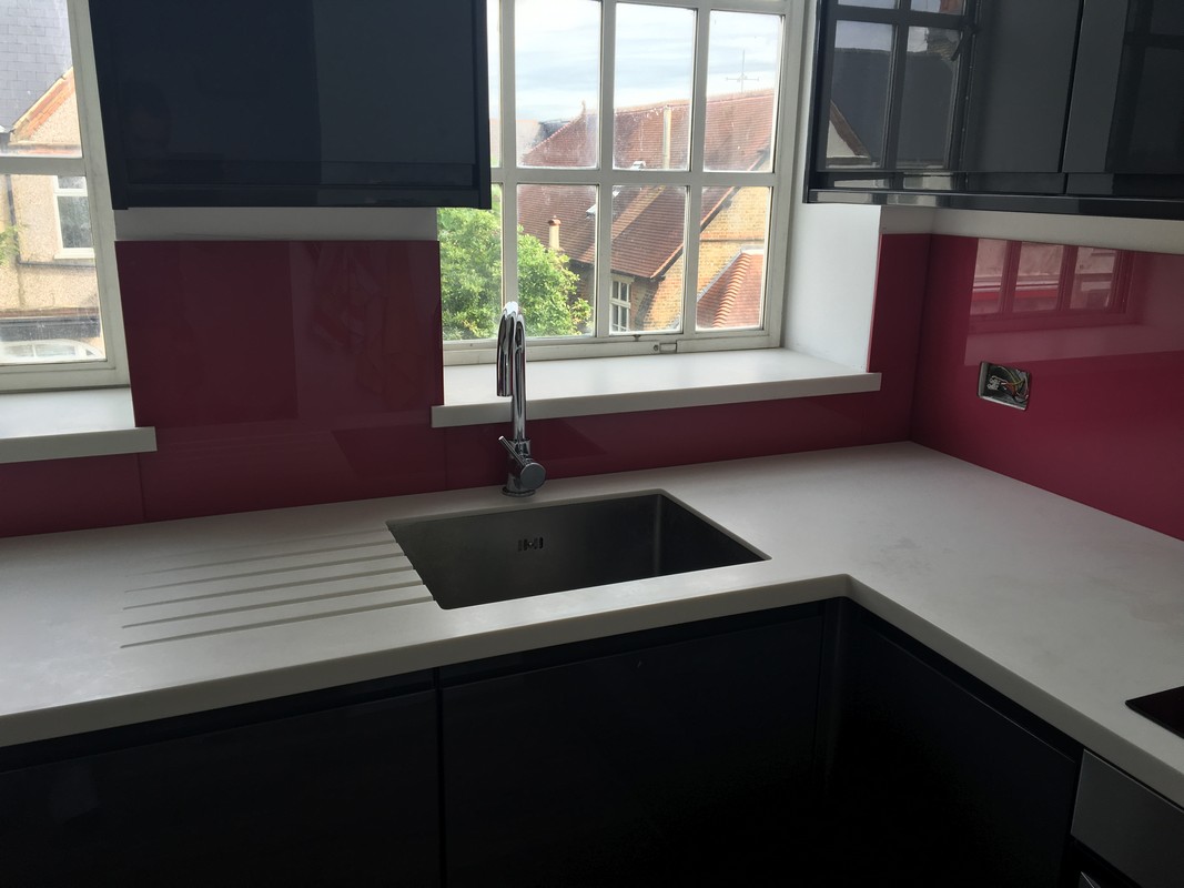 Deep plum coloured glass splashback in modern Streatham Hill kitchen